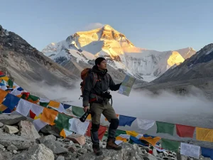 Everest Base Camp Trek with Helicopter Return traveler at sunrise, showcasing mountain backdrop and adventure.
